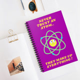 A fun Science themed notebook featuring a cute cartoon atom, with text reading  'Never Trust An Atom, they make up everything!' Background color is bright purple, on the front and black on the back of the notebook. A useful notebook for Shopping lists, school/ college/ University notes, personal notes, making notes of ideas, to do lists and general note taking.   www.ridethestyle.com